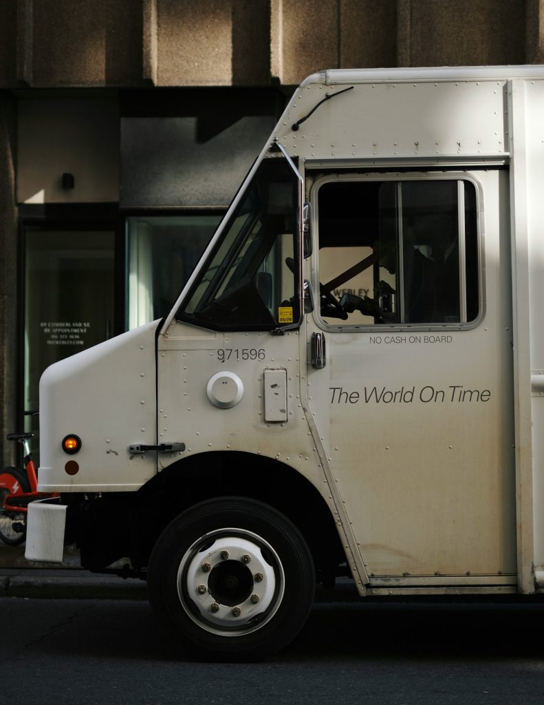 White delivery truck with "the world on time" text.